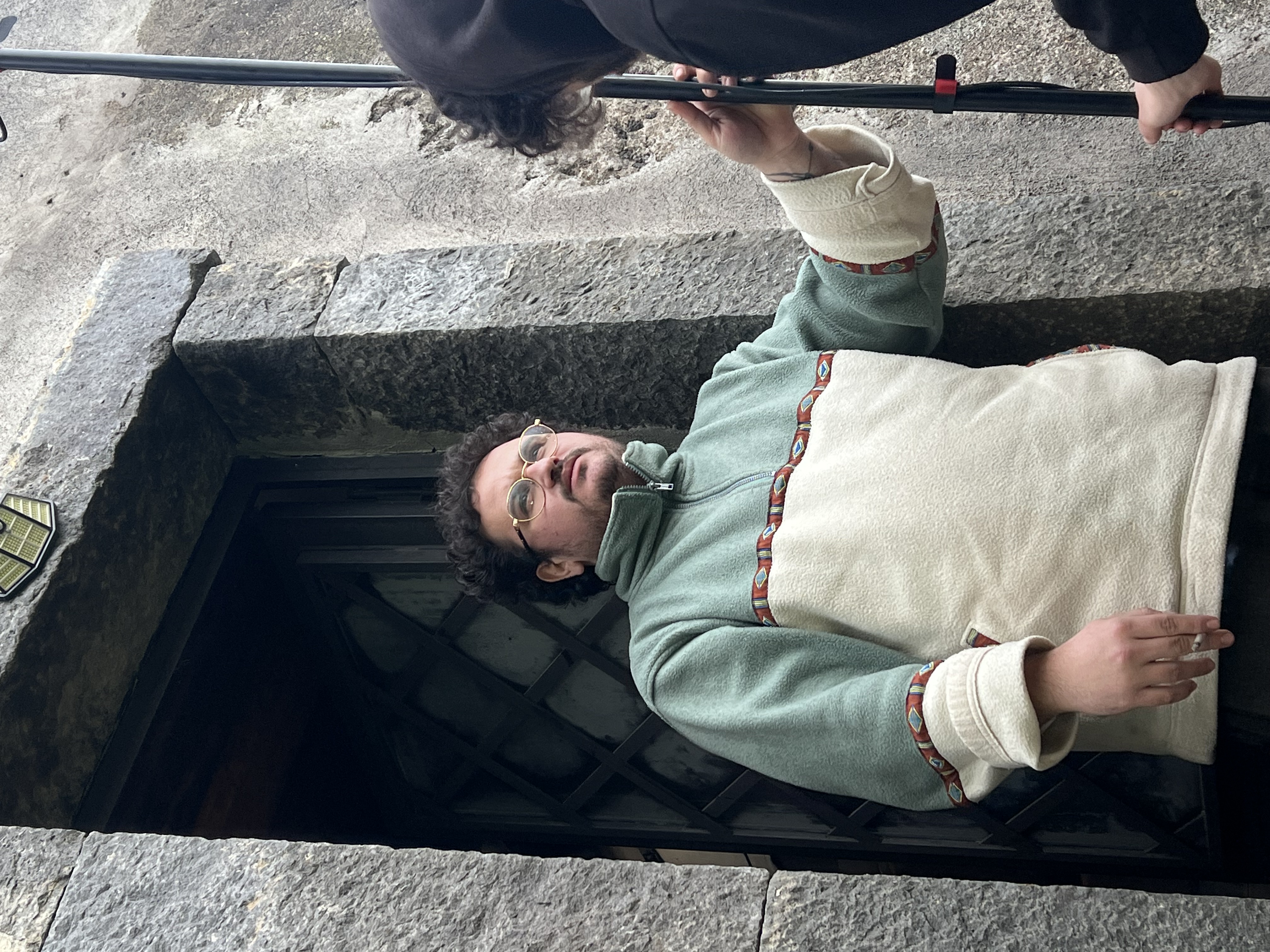 Gianmarco wearing glasses on the Mare Neve set